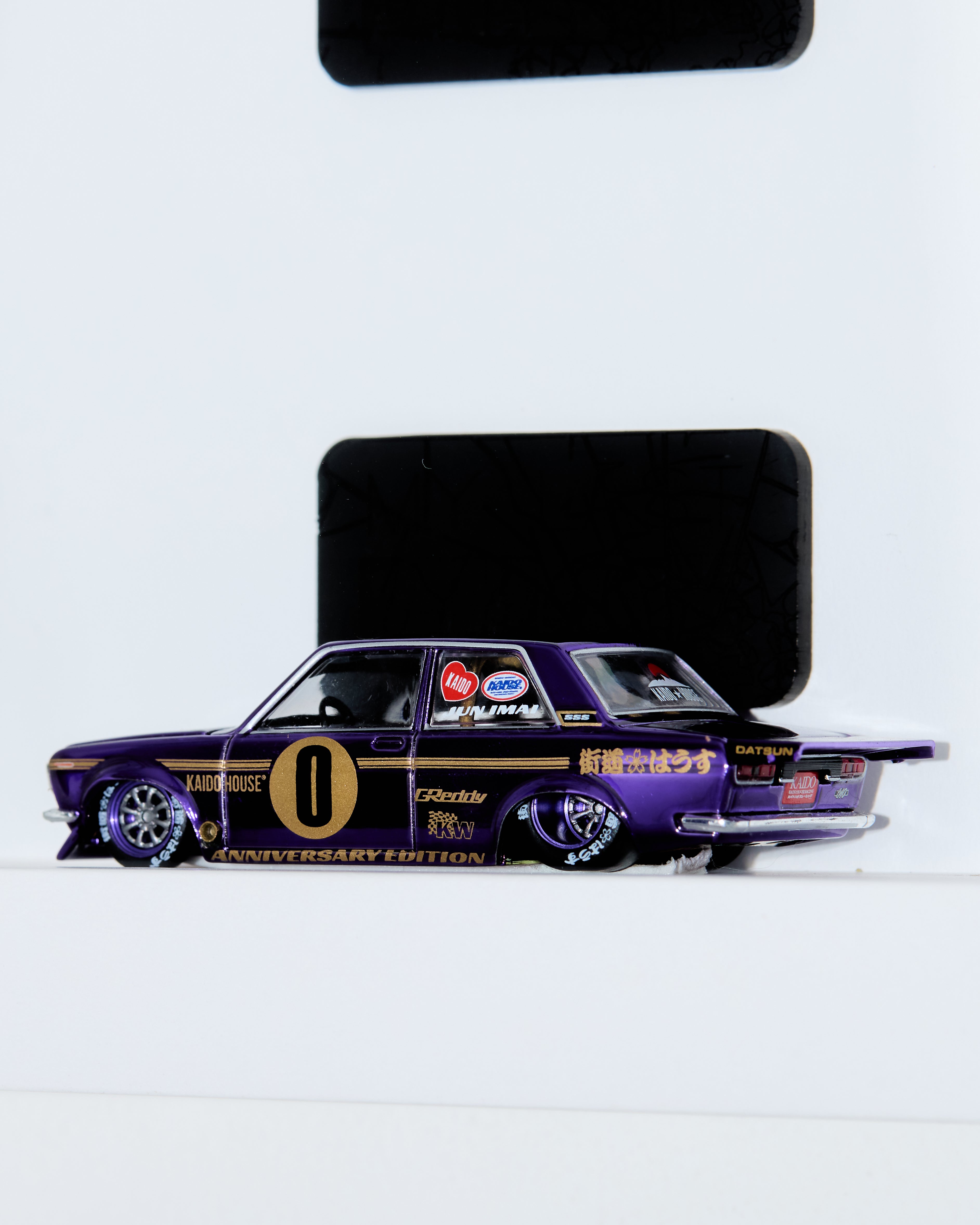 Miniature purple Japanese car. Miniature, scale 1/64