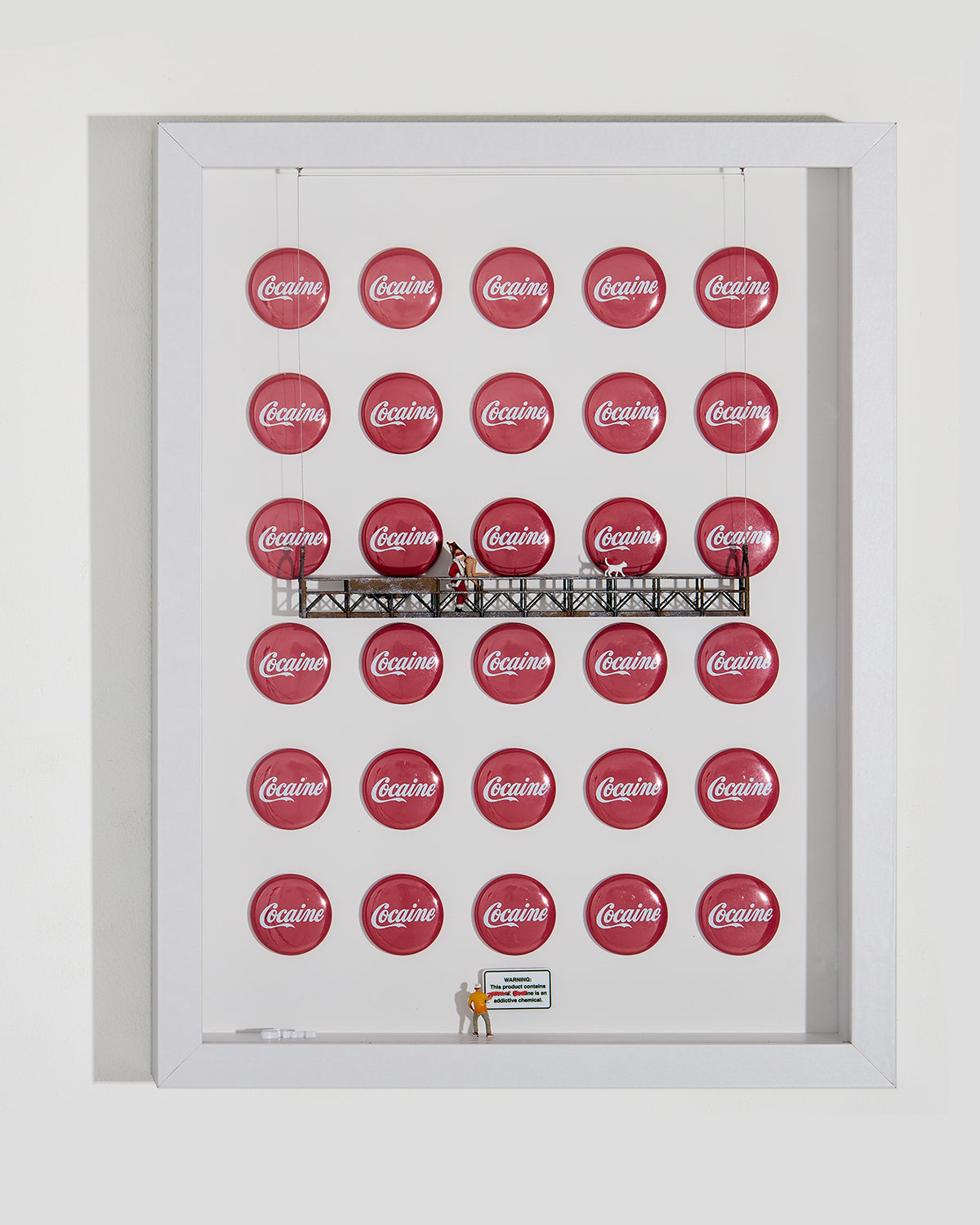 A playful yet unsettling piece in a shadow box contrasting pleasure and addiction. Iconic soda brand is reimagined to question how society disguises danger beneath joyful imagery. Figures express excess and denial, while a warning sign grounds the message: not everything that feels good is harmless. miniature figurines and a platform, with Santa on it.