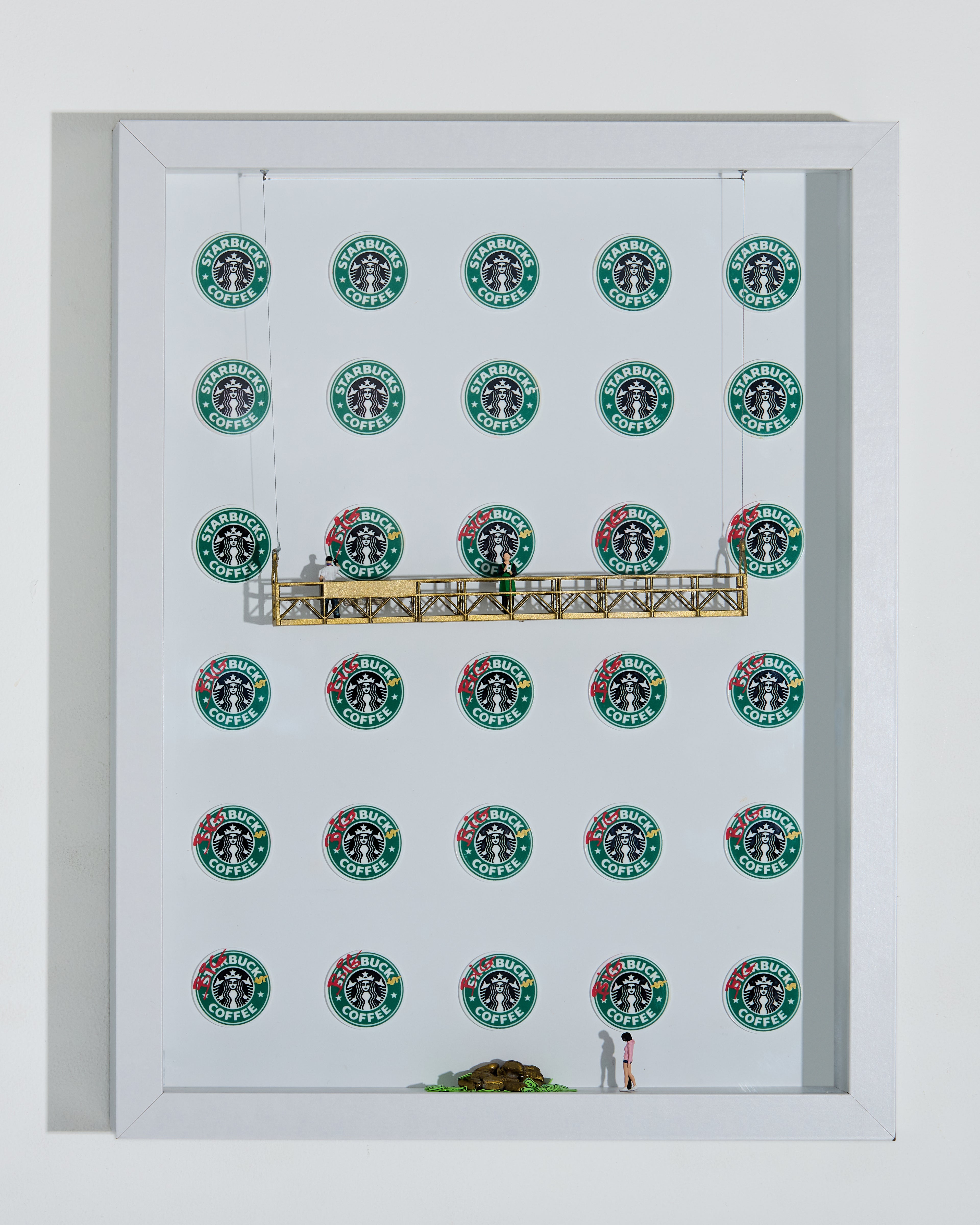 shadow box artwork with Starbucks logo pattern and miniature figurines on a gold platform and a white background. Gold coffee beans and dollars at the bottom.